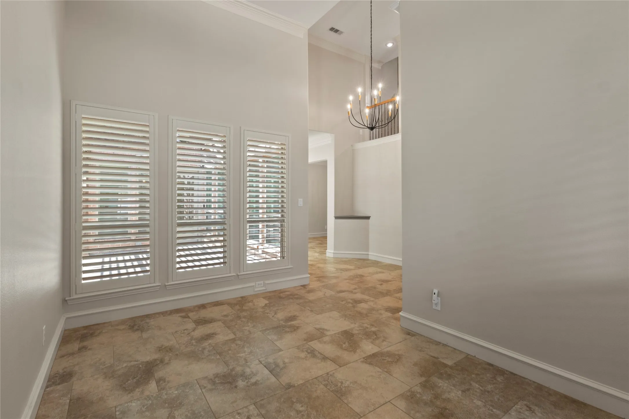 View of the entry and patio. The front windows have slight views of the pond. This living area serves as a great analog multi-purpose space.