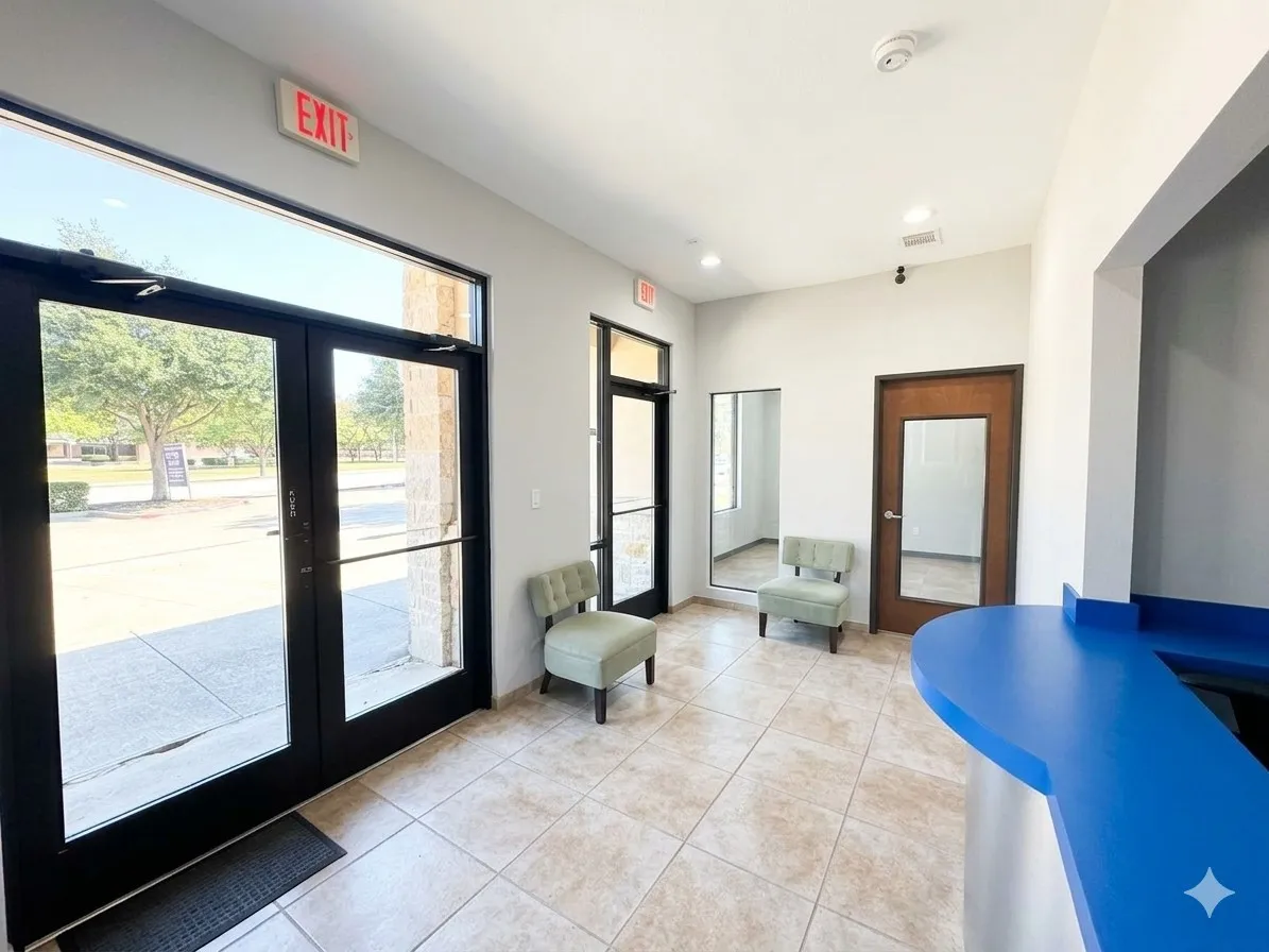 Tile flooring, expansive glass entry doors, recessed lighting, and a built-in reception desk
