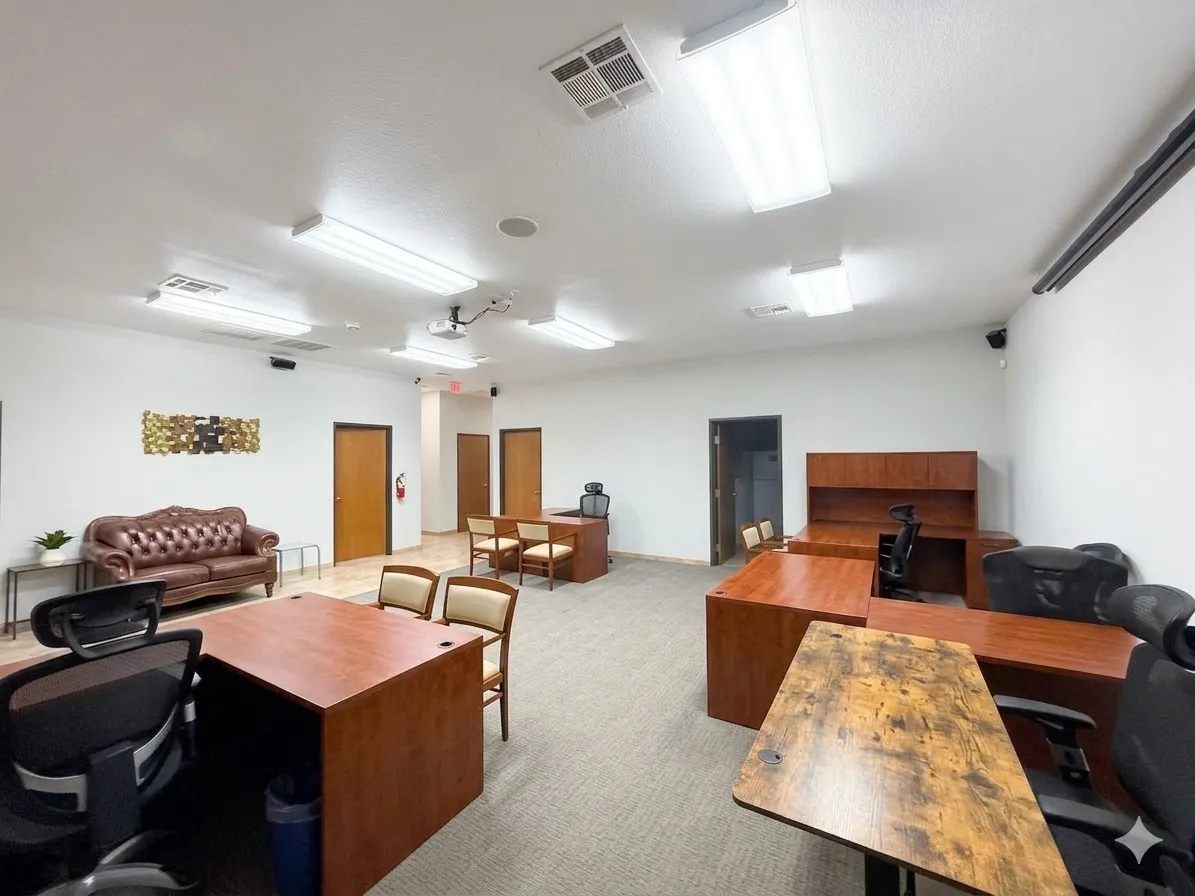 Spacious interior with neutral carpeting, recessed lighting, and multiple wood-finish doors