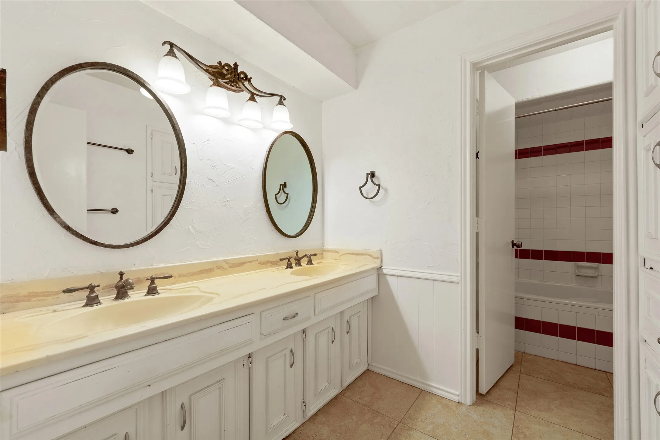 Dual vanity with light-toned countertop and integrated sinks