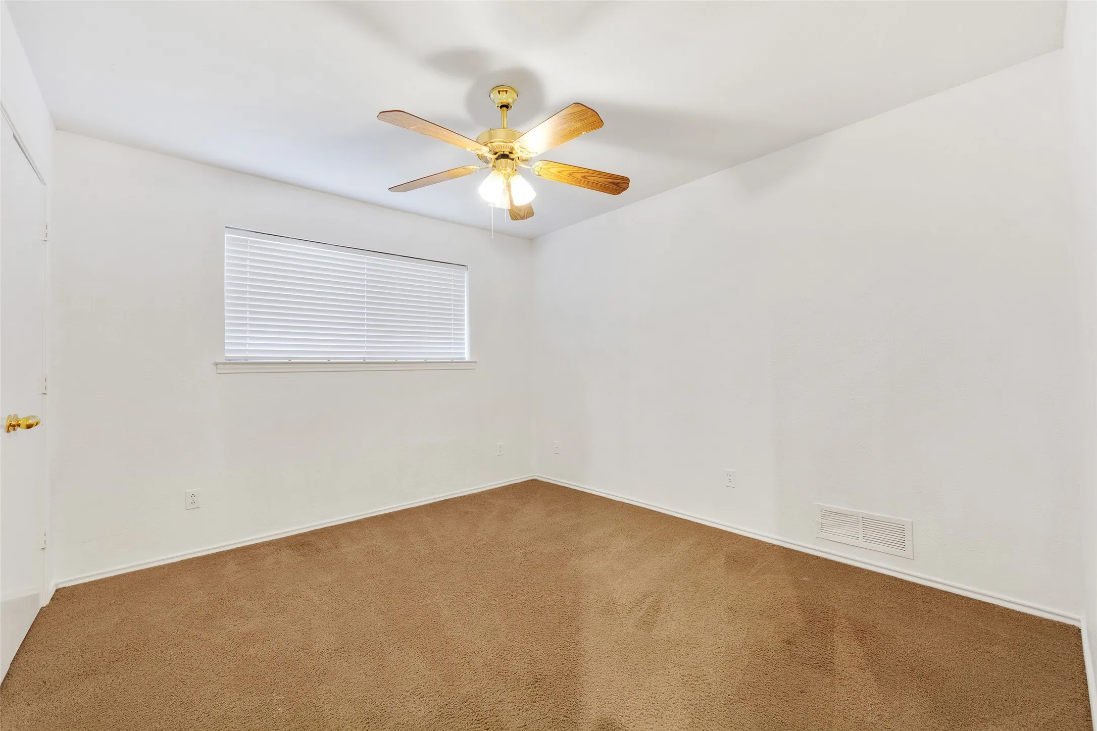 Ceiling fan with light fixture, window with blinds, and wall-to-wall carpeting