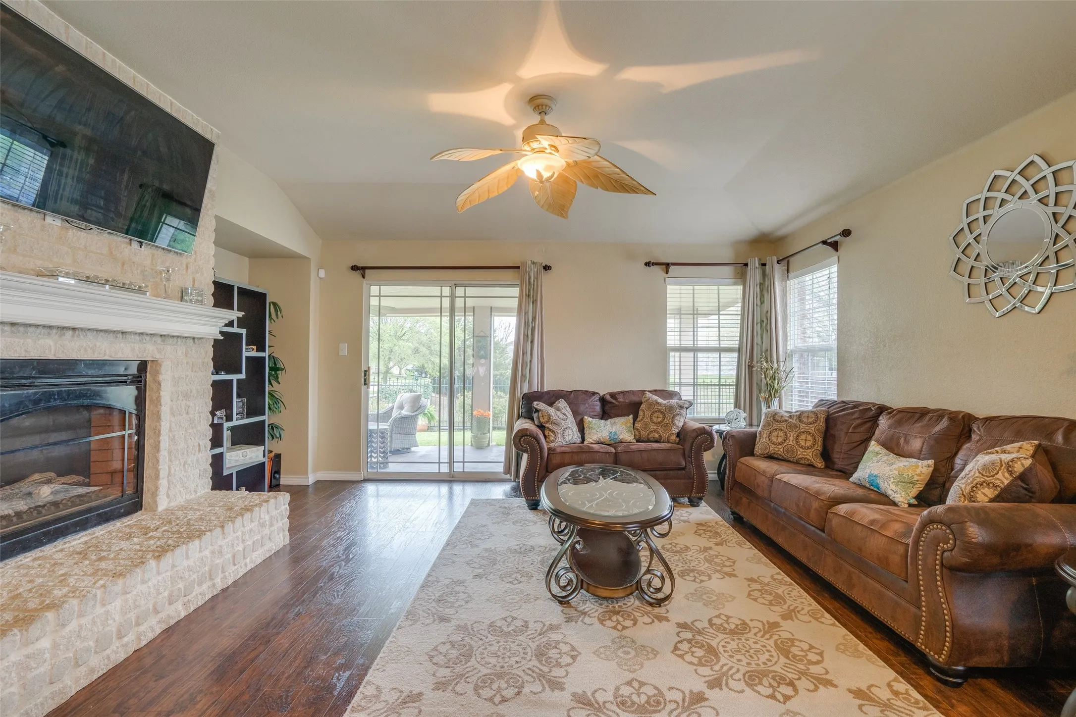 Fireplace featuring a light-colored brick surround