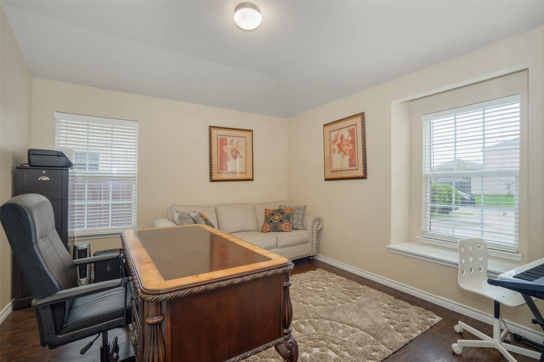 Recessed lighting, wood-finish flooring, and multiple windows with blinds