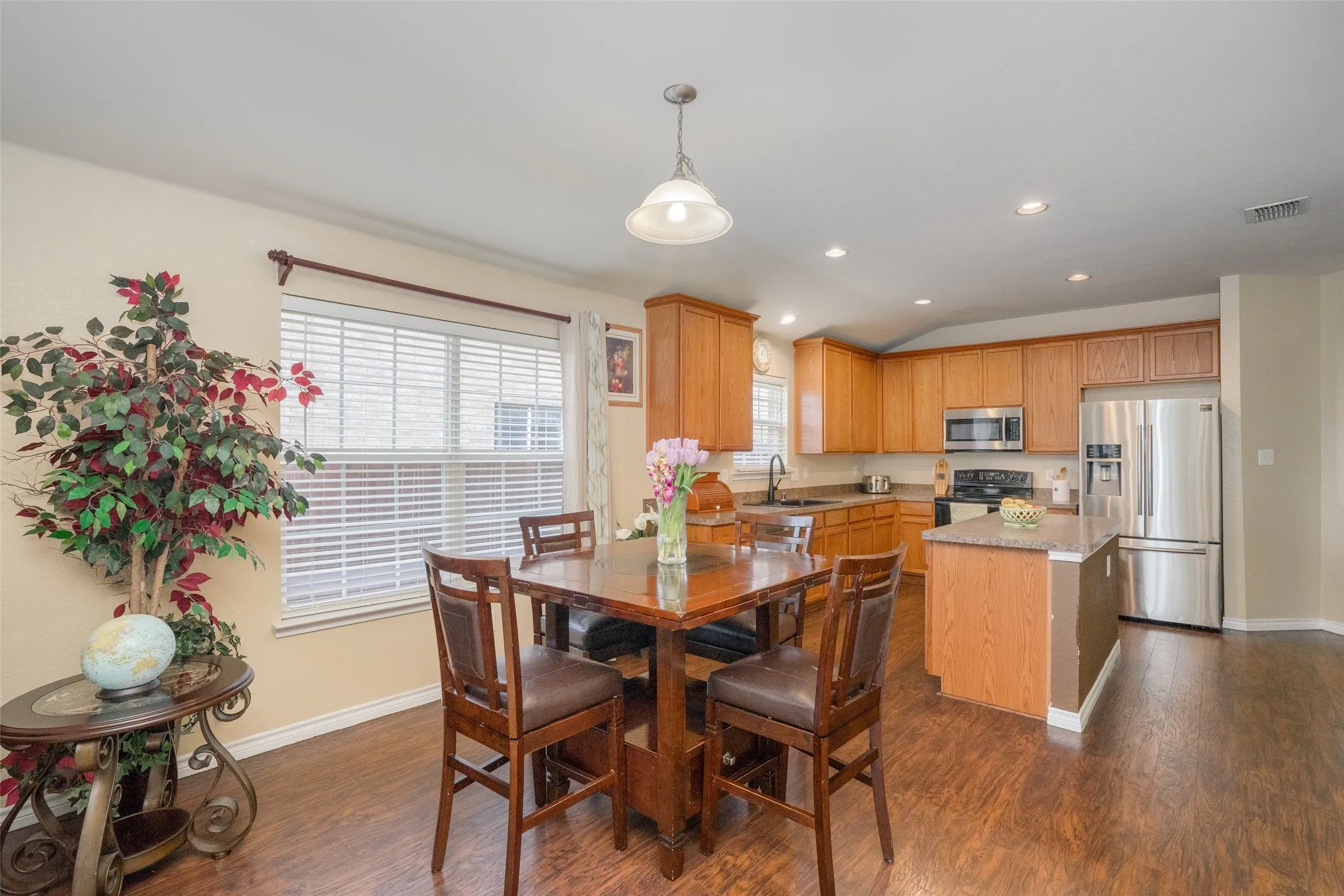 Kitchen featuring wood-finish flooring, recessed lighting, wood cabinetry, and stainless steel appliances