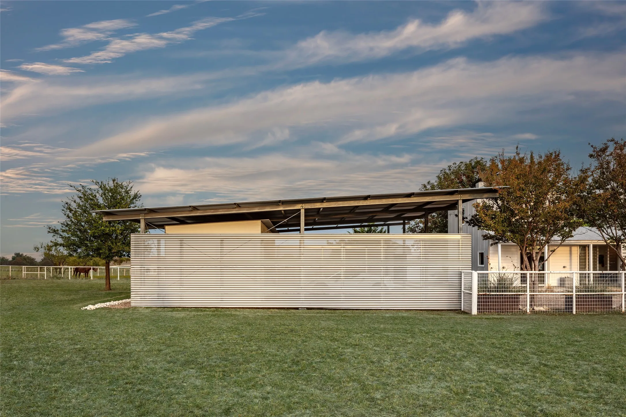 Side view of the three-car carport with electric vehicle charging port.