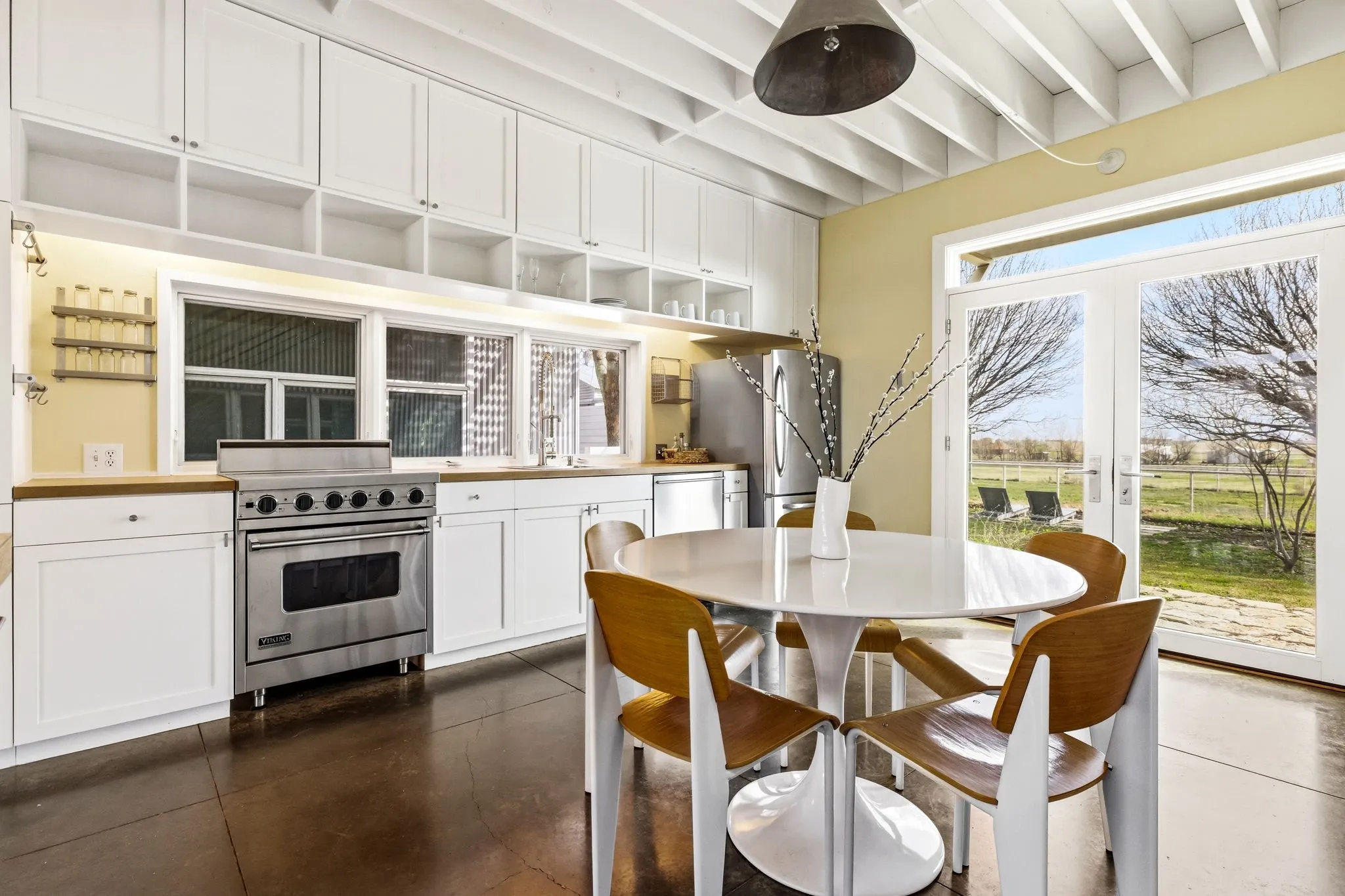 Crisp white cabinetry with generous storage, a Viking stove and cooktop, and stainless steel appliances.