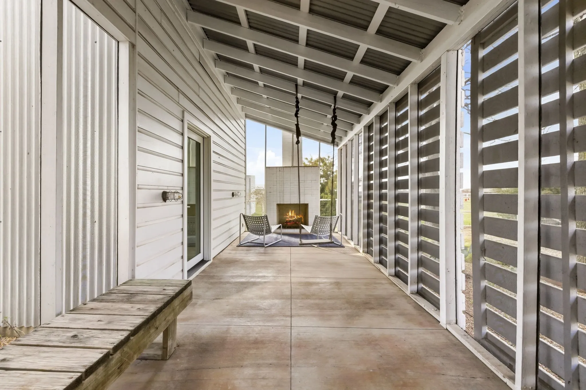 Enclosed patio featuring a wood-burning brick fireplace