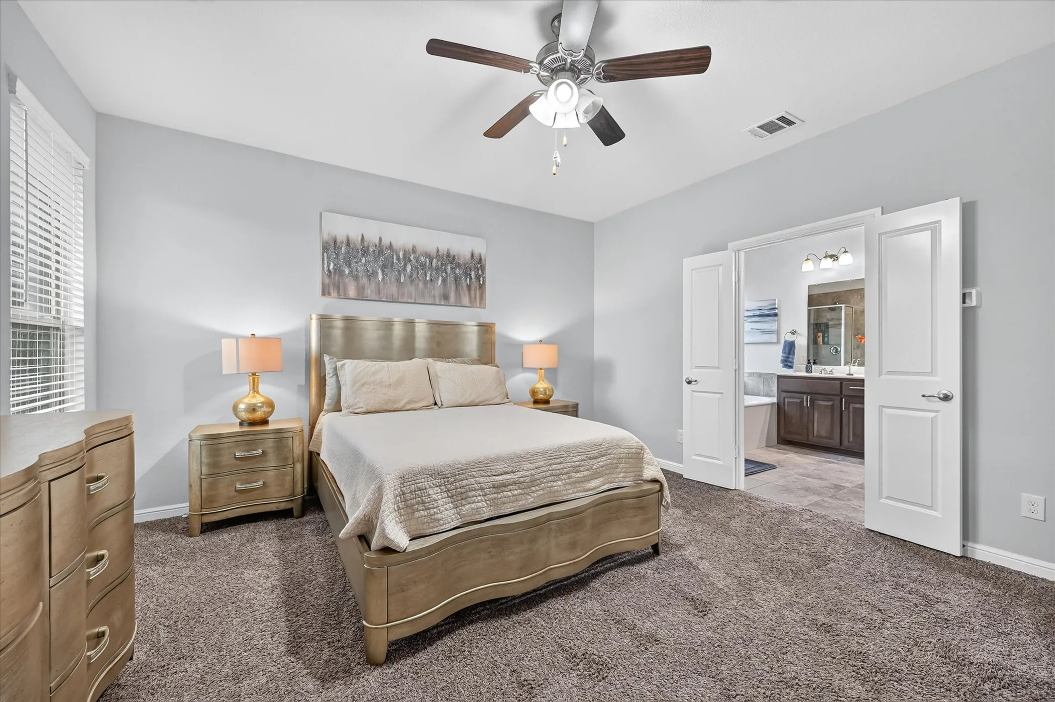 Spacious room featuring neutral carpeting, a ceiling fan with integrated lighting, and a window with horizontal blinds