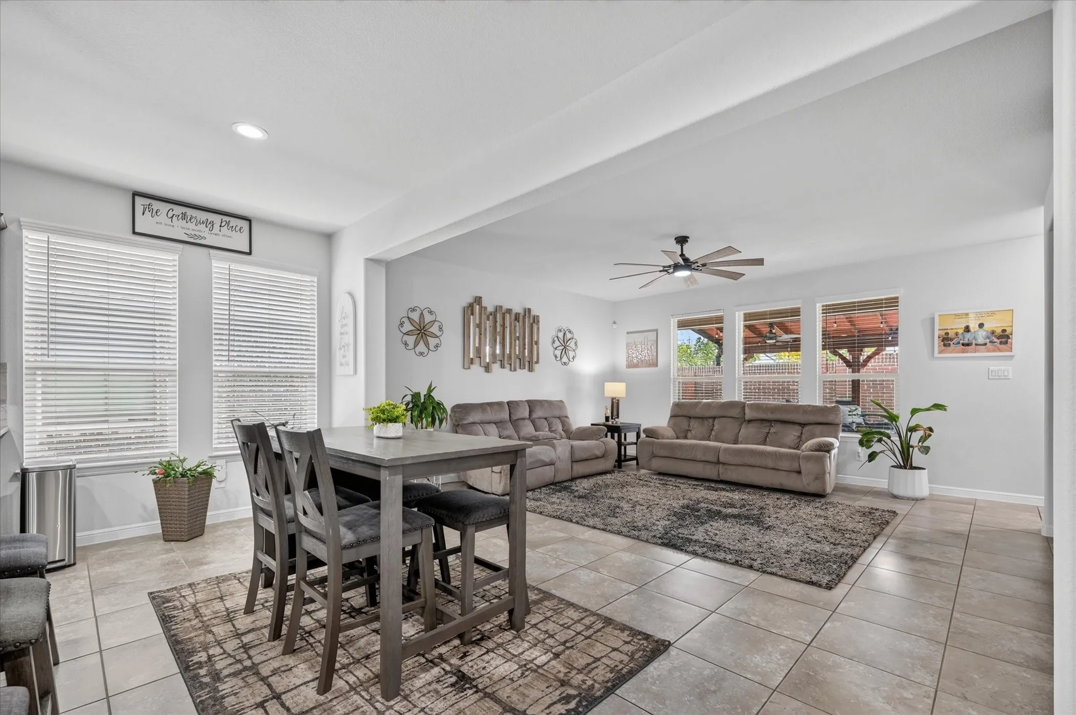 Recessed lighting, ceiling fan, expansive windows, tiled flooring, and an open-concept layout