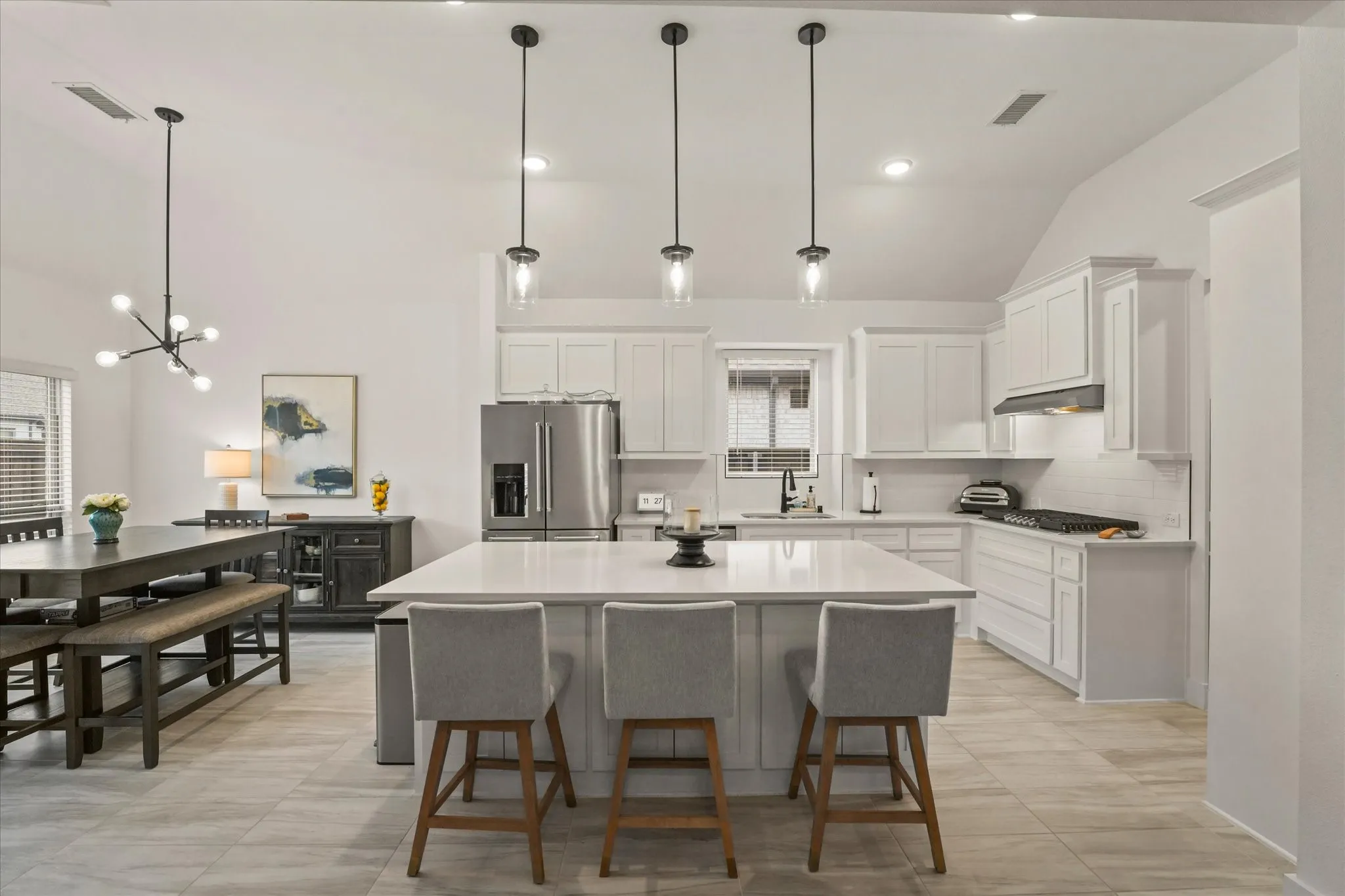 Modern kitchen with white cabinetry and stainless steel appliances