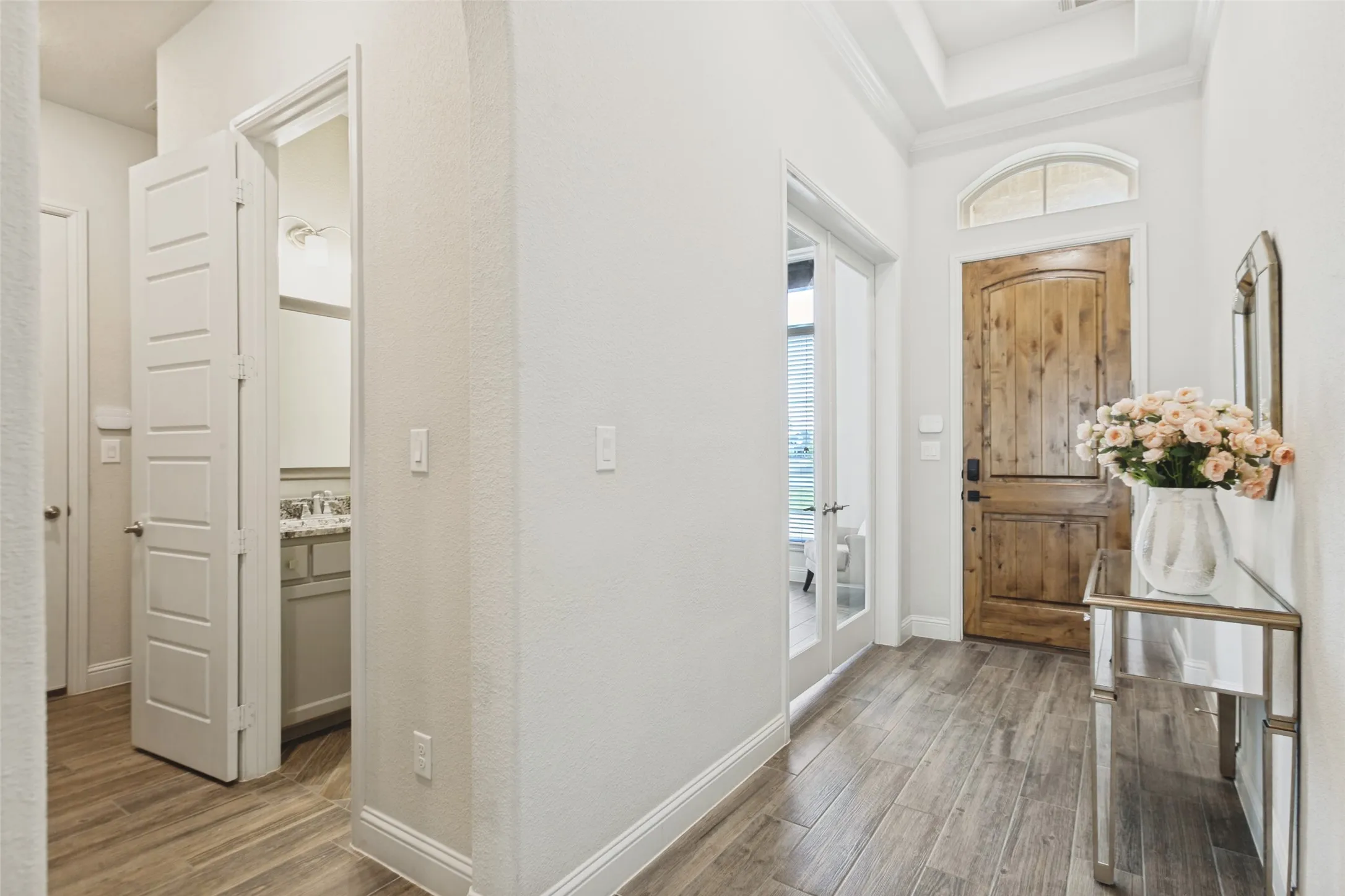Hallway to half bath and mud area