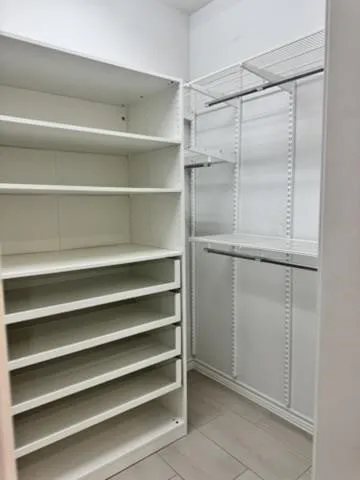Custom closet system featuring built-in shelving, wire racking, and clothing rods