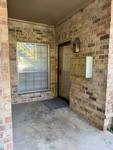 Brick exterior with a covered entry