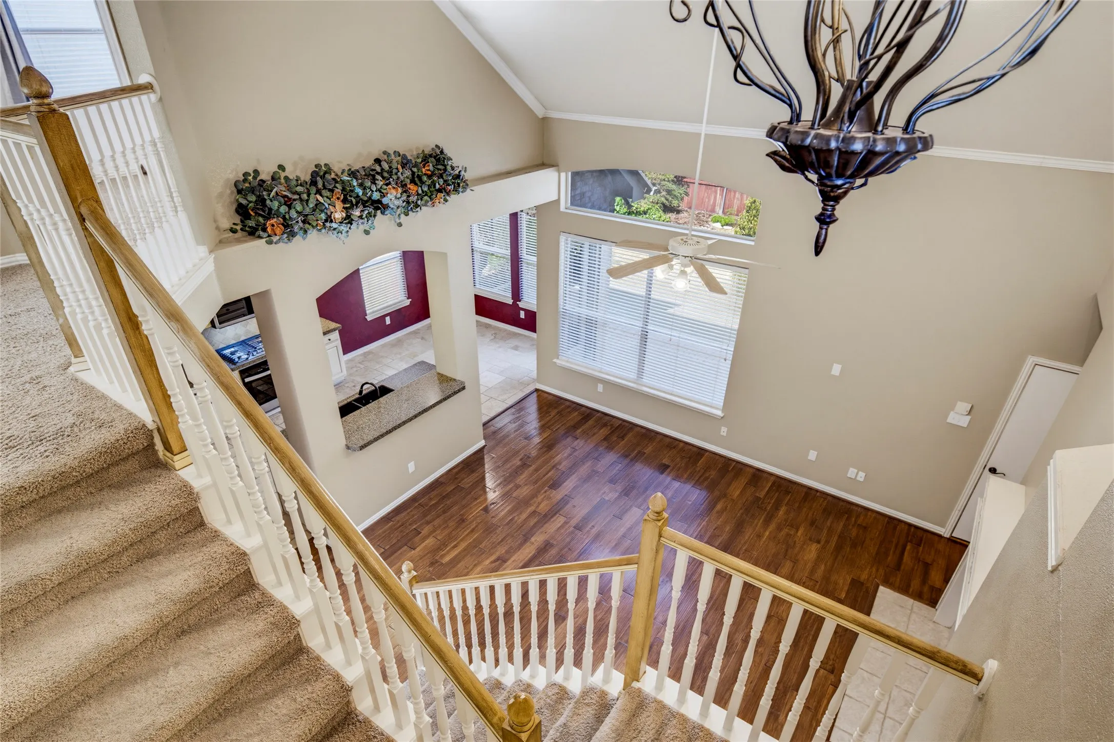 Two-story living area with high vaulted ceilings and wood-finish flooring
