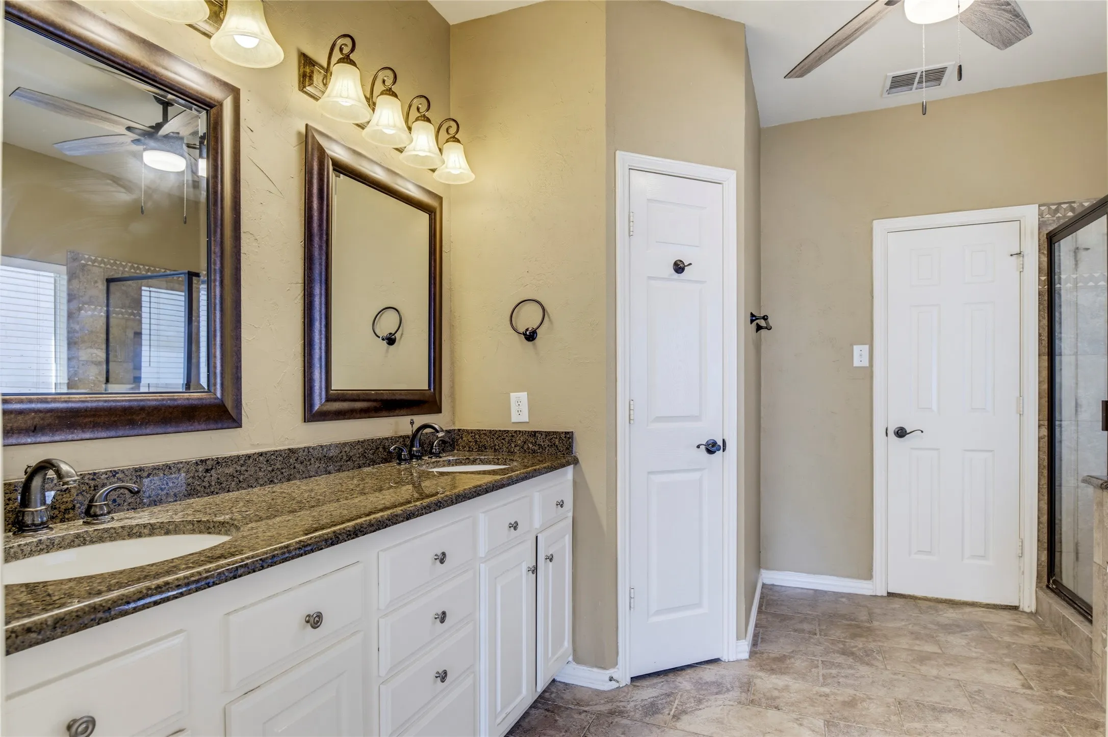 Dual vanity with undermount sinks and dark speckled countertop