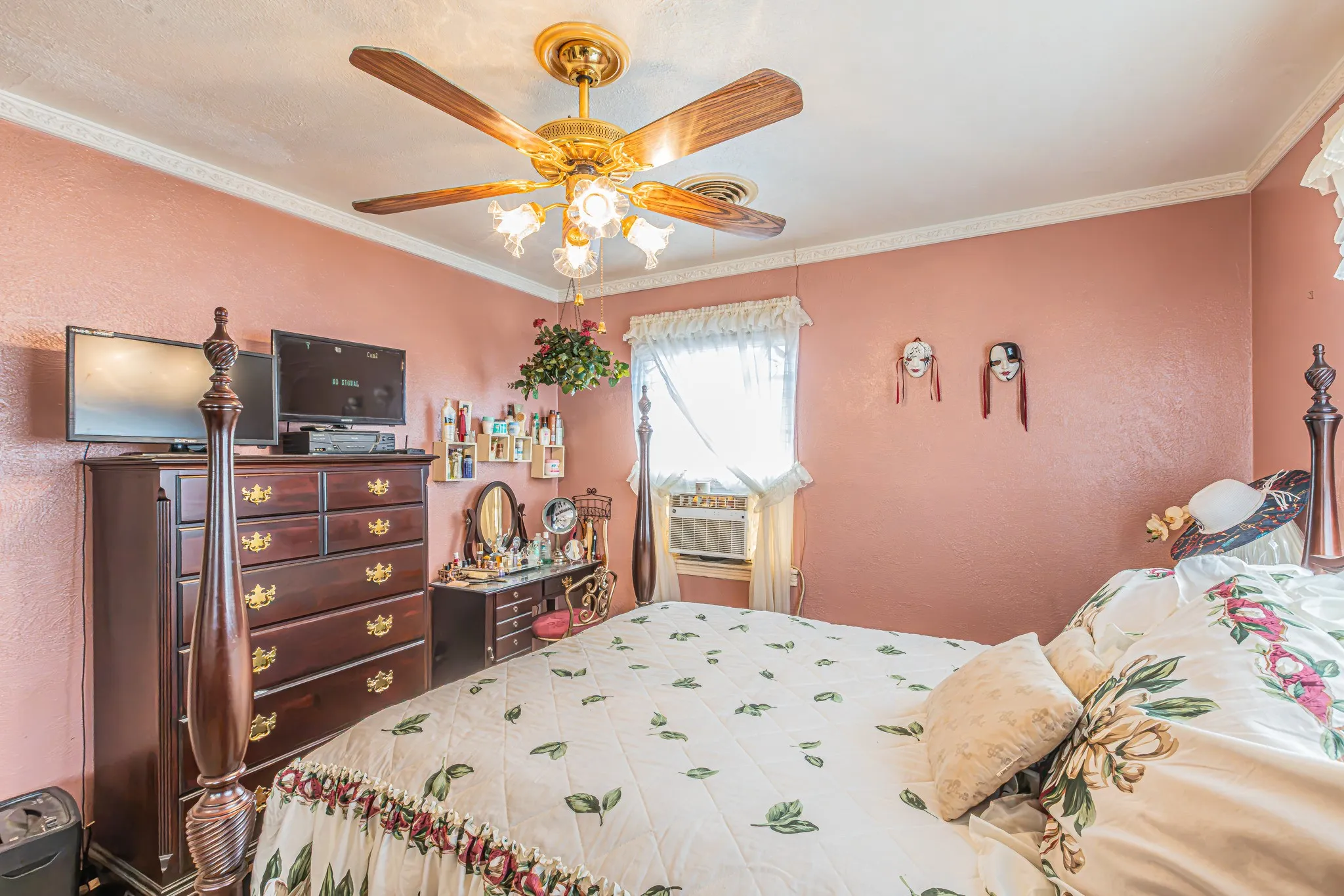 Ceiling fan with integrated lighting, window-mounted air conditioning unit, and crown molding