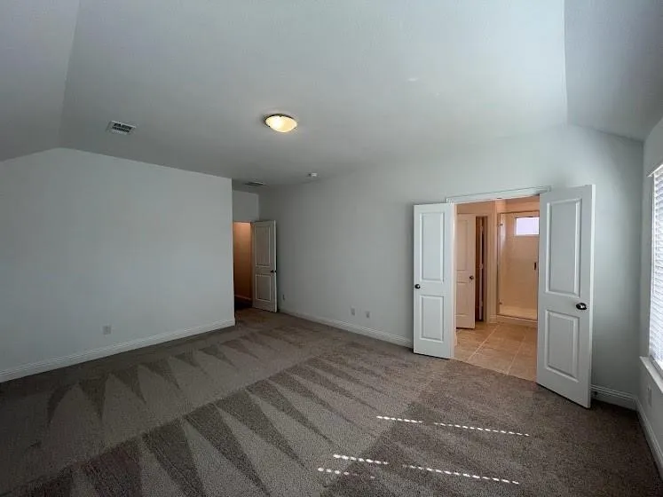 Vaulted ceiling, recessed lighting, double-door entry, tiled flooring, built-in shower