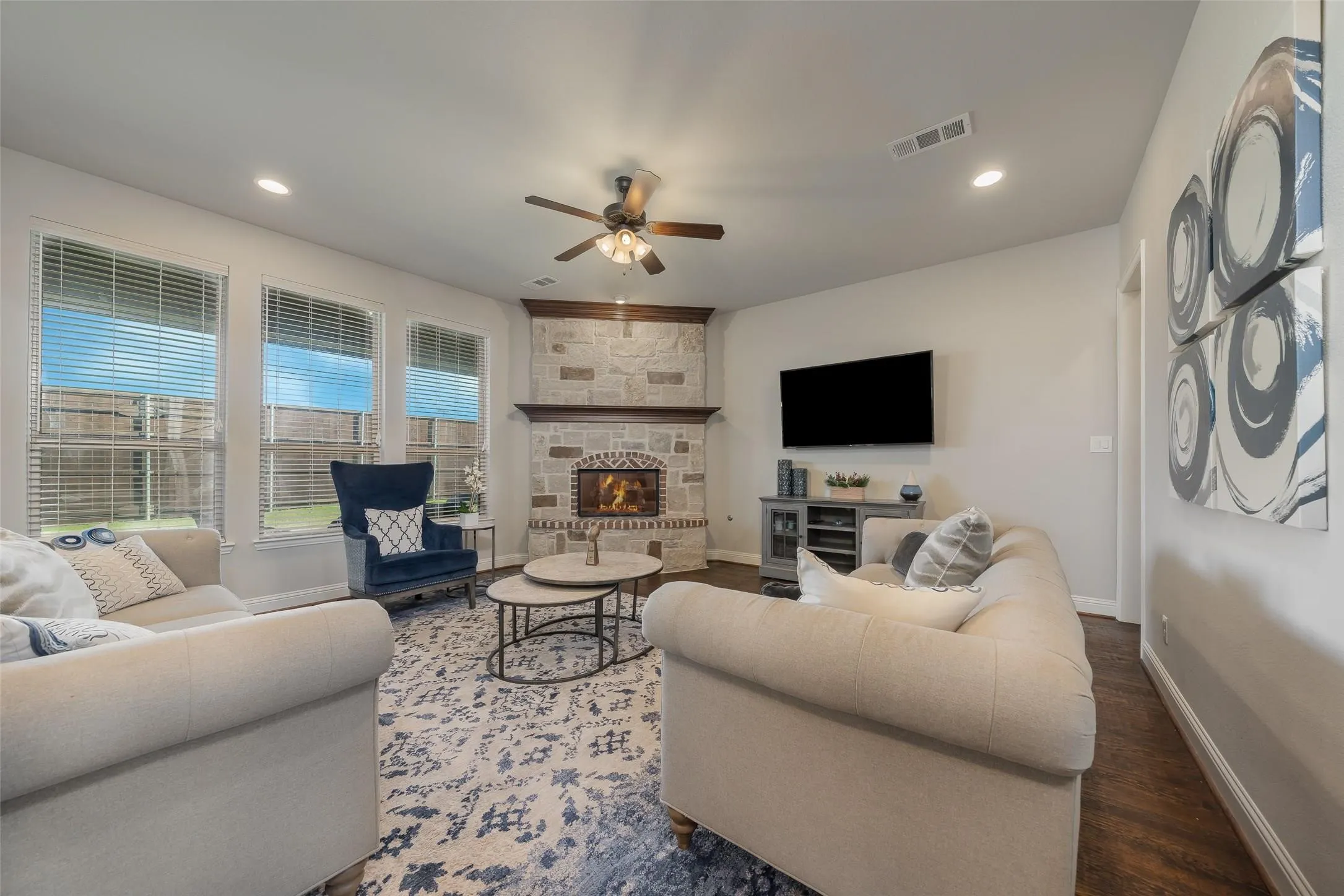 Living room with  hard wood, ceiling fan, and a fireplace