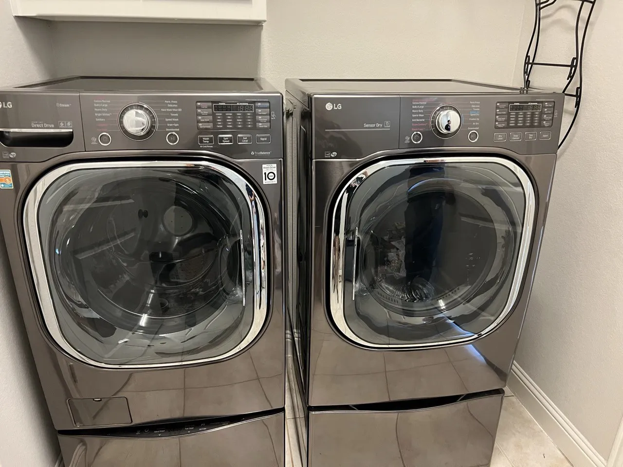 Laundry area featuring tile flooring and washing machine and clothes dryer. Both included.