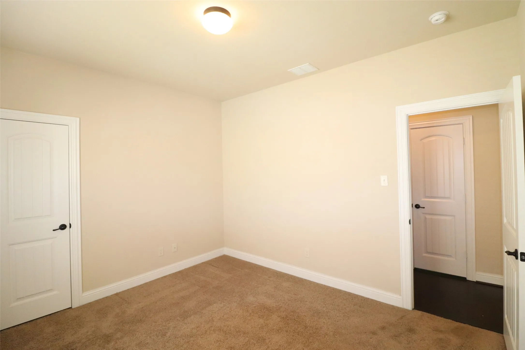 Neutral-toned walls complement plush carpeting
