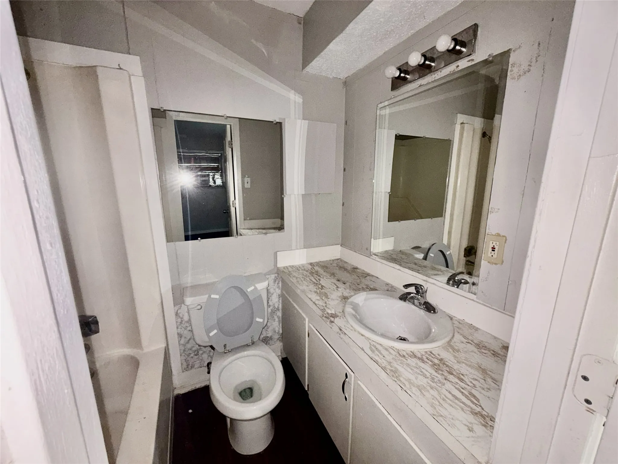 Modern bathroom featuring dual vanity with marble-look countertop, round vessel sink, and chrome faucet