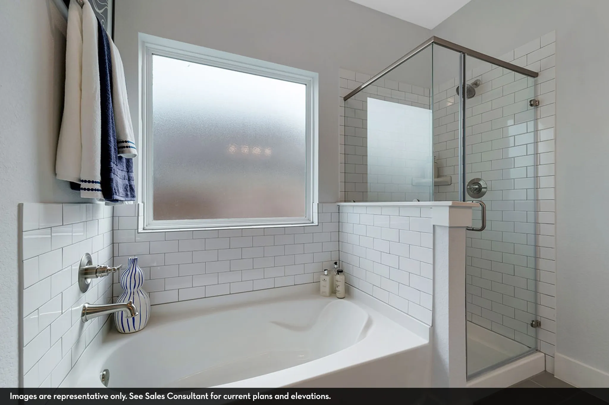 Built-in soaking tub with subway tile surround, frosted window, and a separate glass-enclosed shower