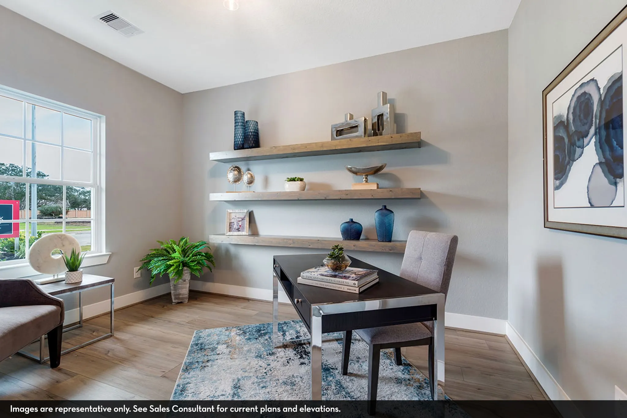 Light wood-finish flooring, a large window with white trim, and a neutral wall color complement the built-in floating shelves