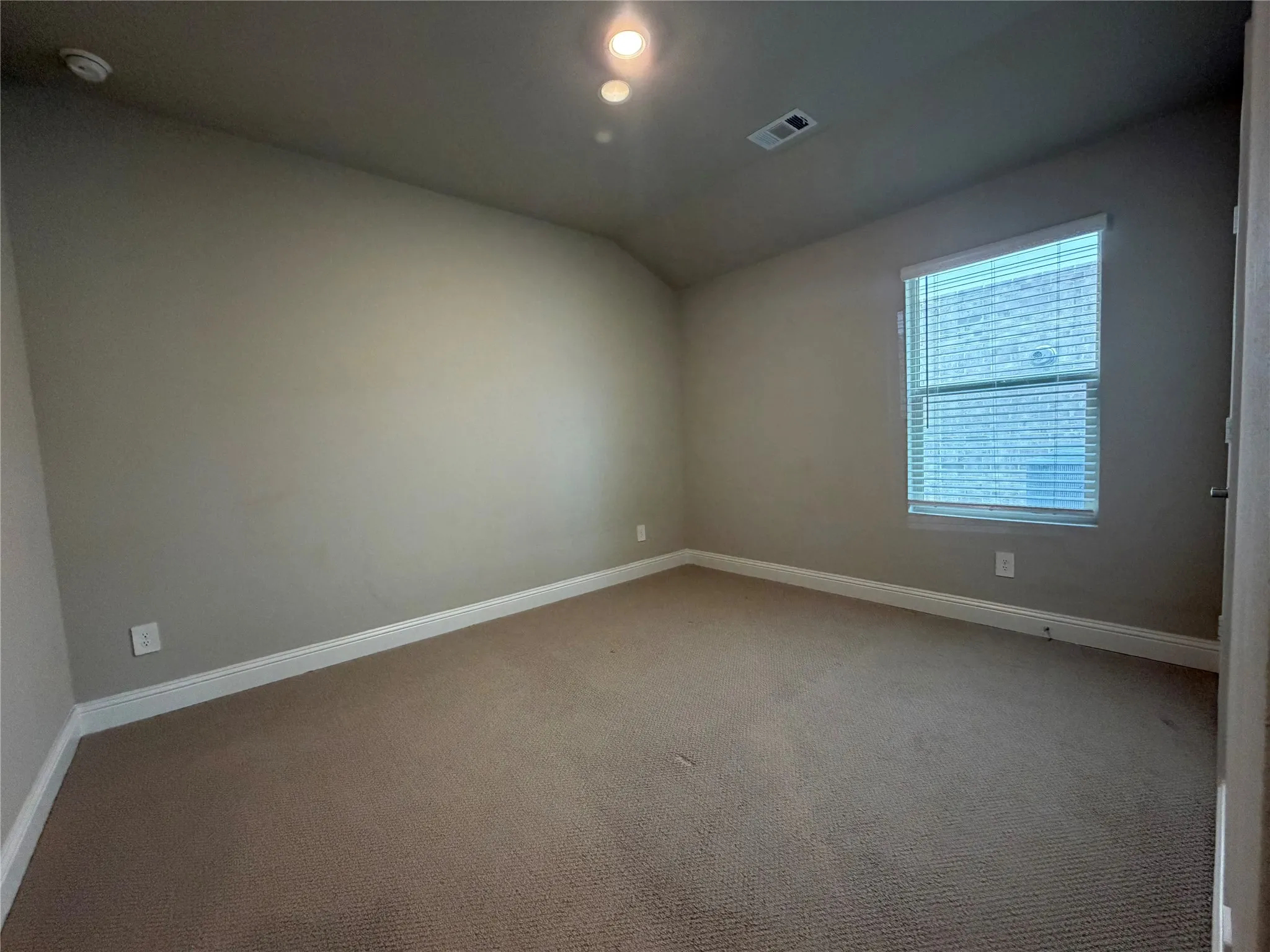 Carpeted flooring, neutral wall tones, recessed lighting, window with blinds