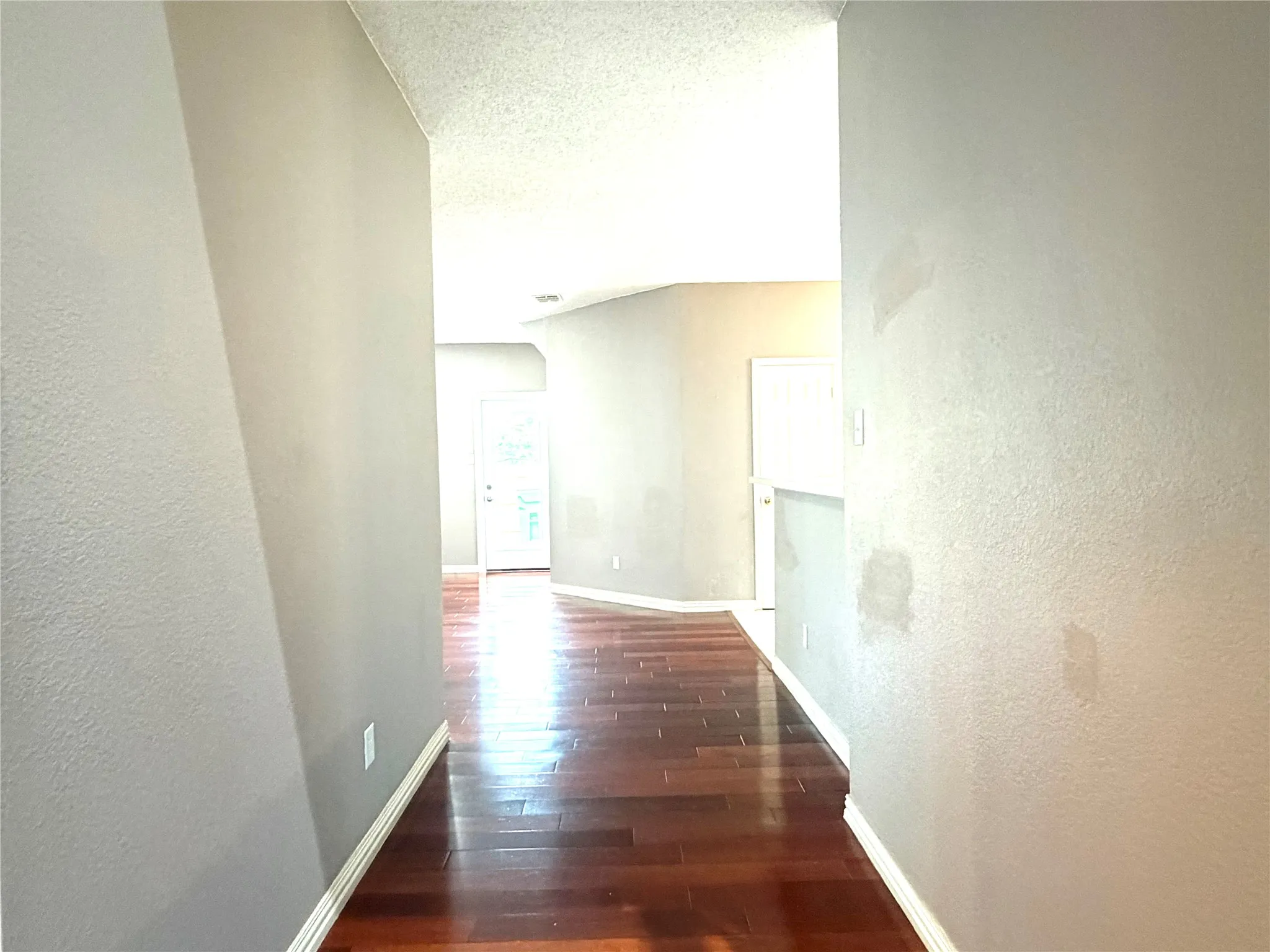 Wood-finish flooring throughout the hallway