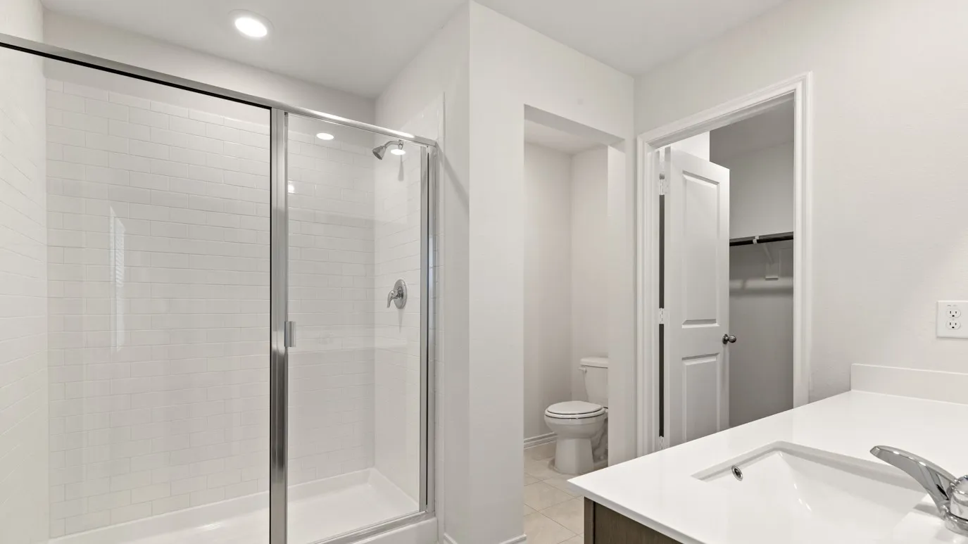 Walk-in shower with subway tile surround and glass enclosure