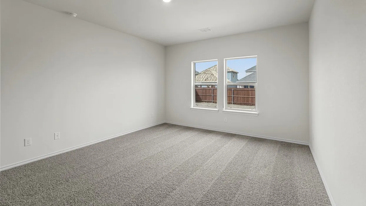 Room featuring neutral wall finishes and grey textured carpeting
