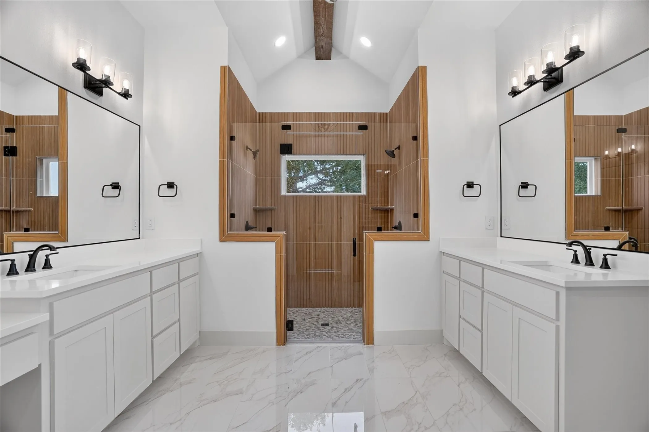 Dual vanities with white cabinetry and countertops