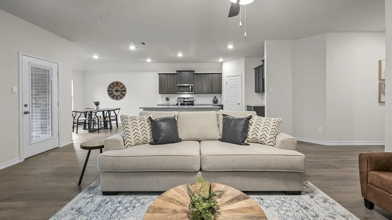 Open-concept living space featuring wood-finish flooring, recessed lighting, and a ceiling fan