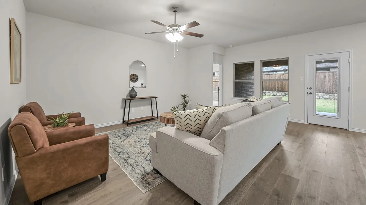 Wood-finish flooring, ceiling fan, and white walls