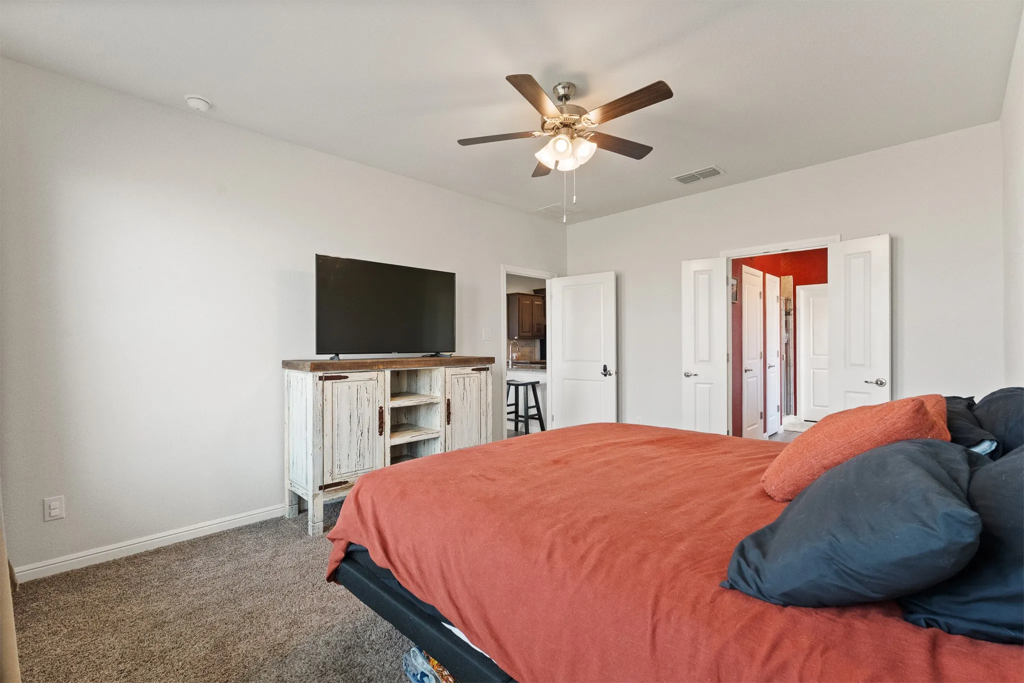 Ceiling fan with integrated lighting, recessed ceiling lights, white interior doors, and neutral wall tones