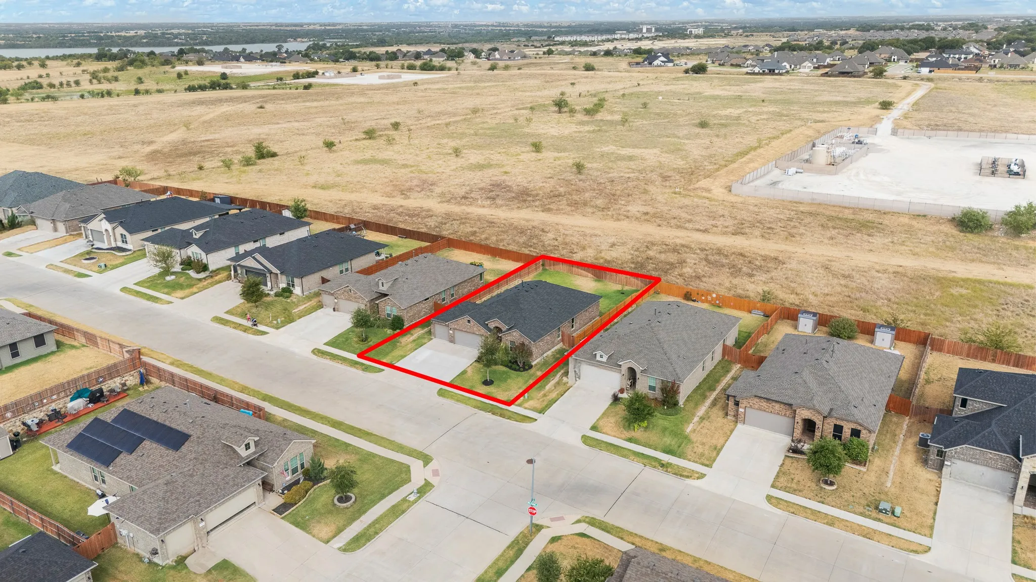 Single-story residence with a two-car garage, concrete driveway, and a fenced yard