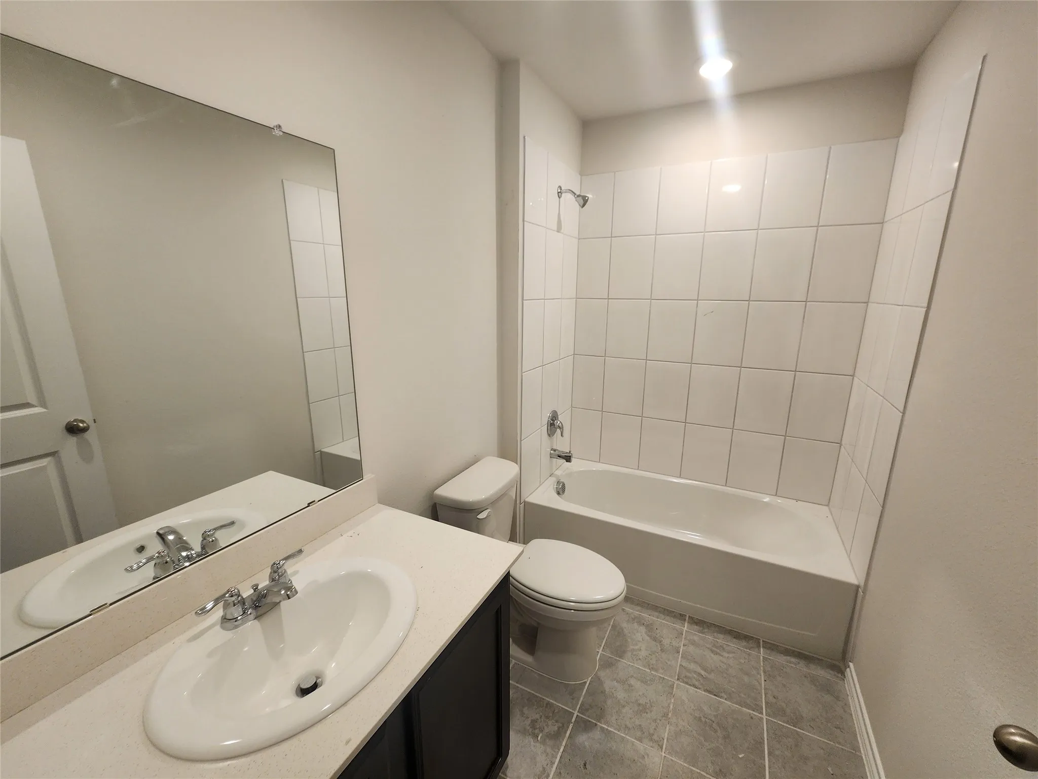 White vanity with an integrated sink, polished chrome faucet, and a large wall-mounted mirror