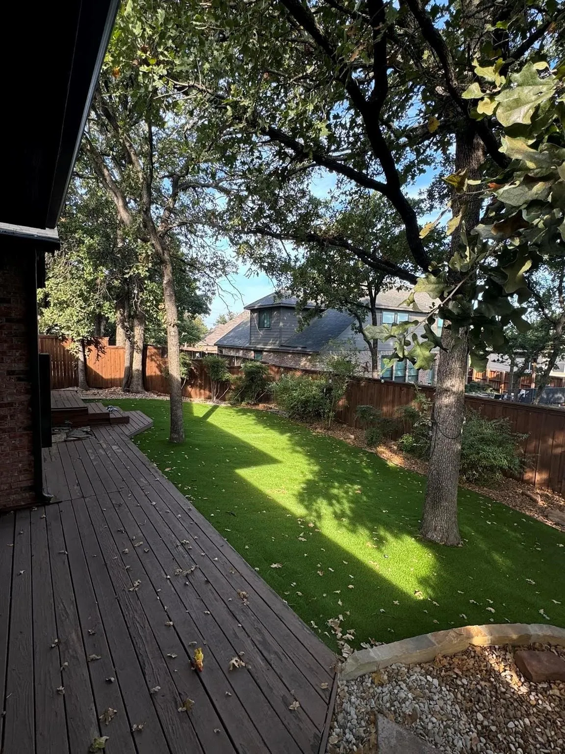 Retreat to the cozy, tree-covered deck surrounded by mature landscaping