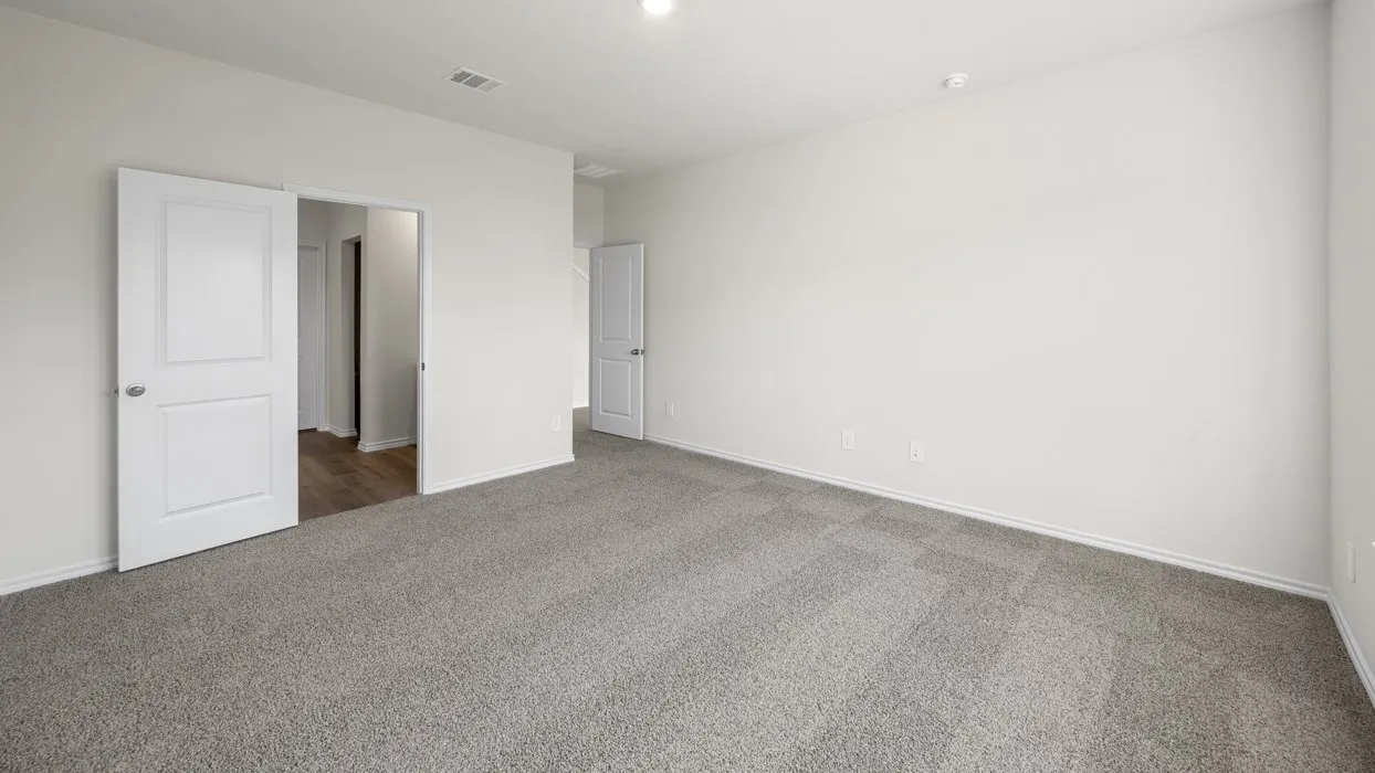 Expansive room featuring light gray carpet, white walls, recessed lighting, and white interior doors