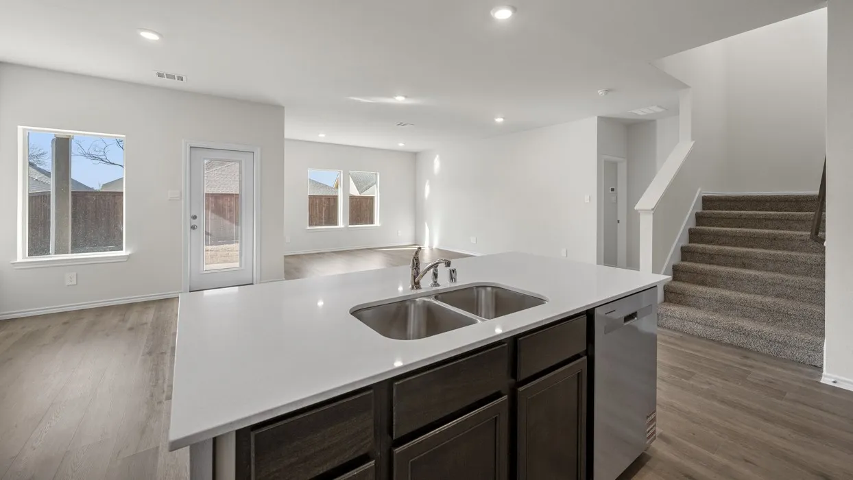 Kitchen island with an undermount double basin sink and stainless steel dishwasher