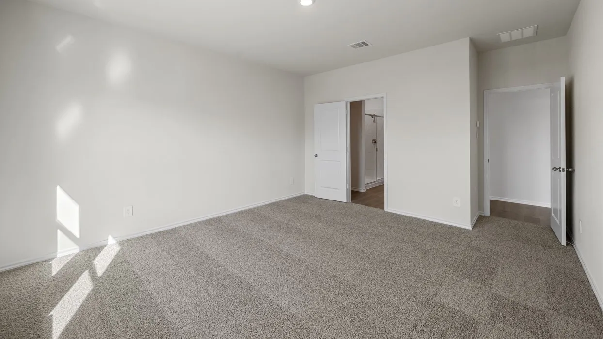 Spacious room featuring neutral carpeting, white walls, and a recessed light fixture