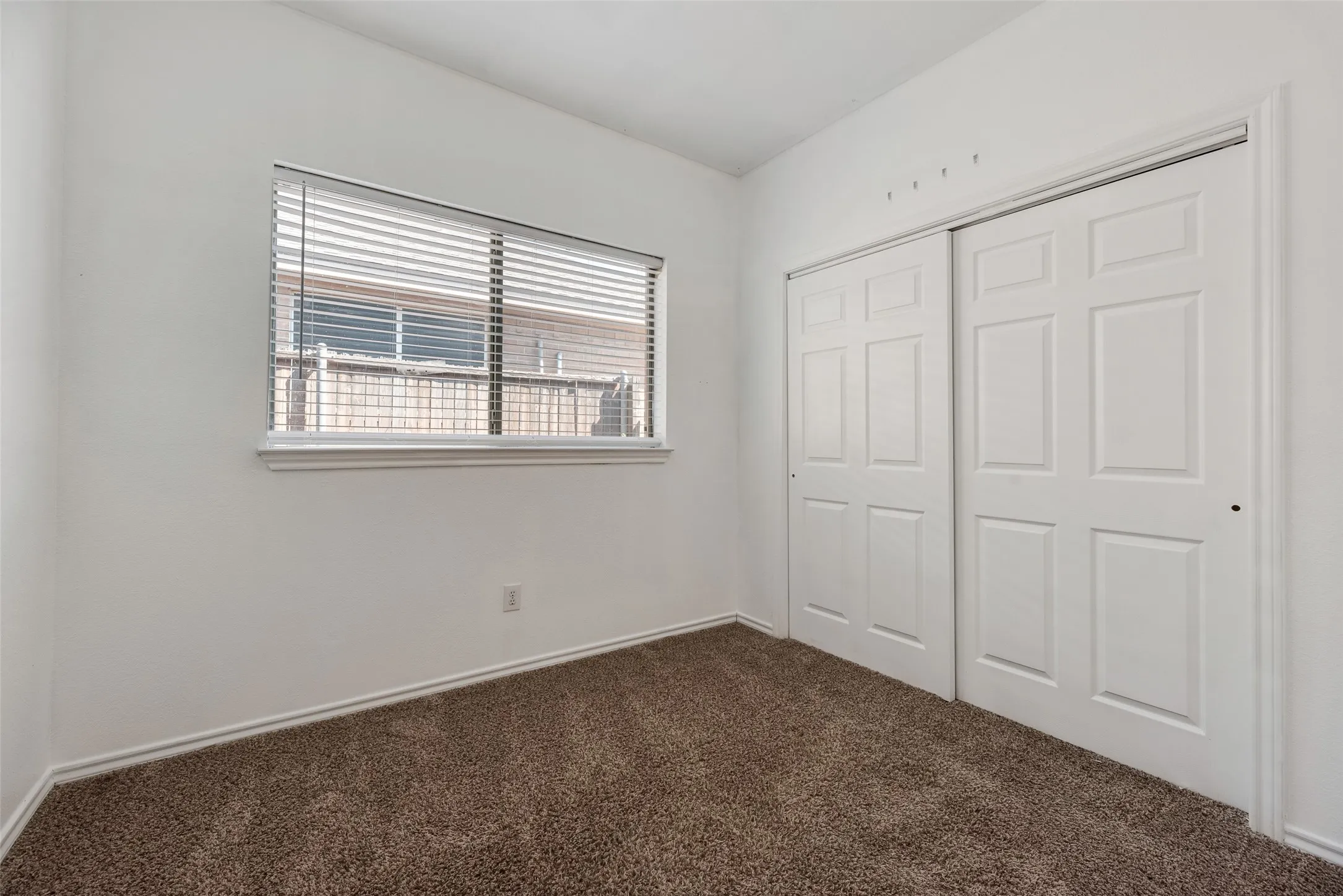 Neutral-toned carpeting paired with white walls