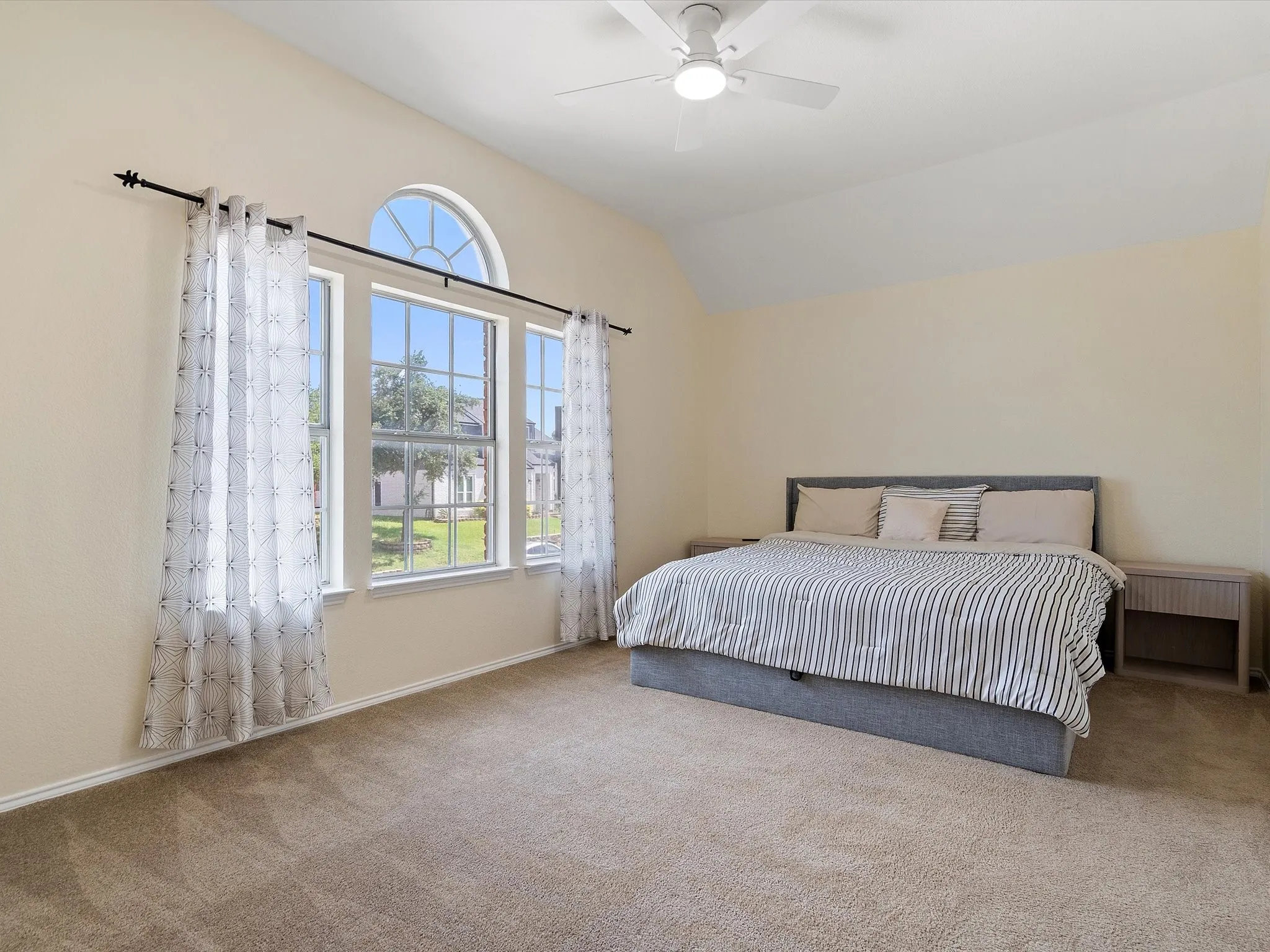 Bedroom featuring carpet floors, lofted ceiling, and a ceiling fan
