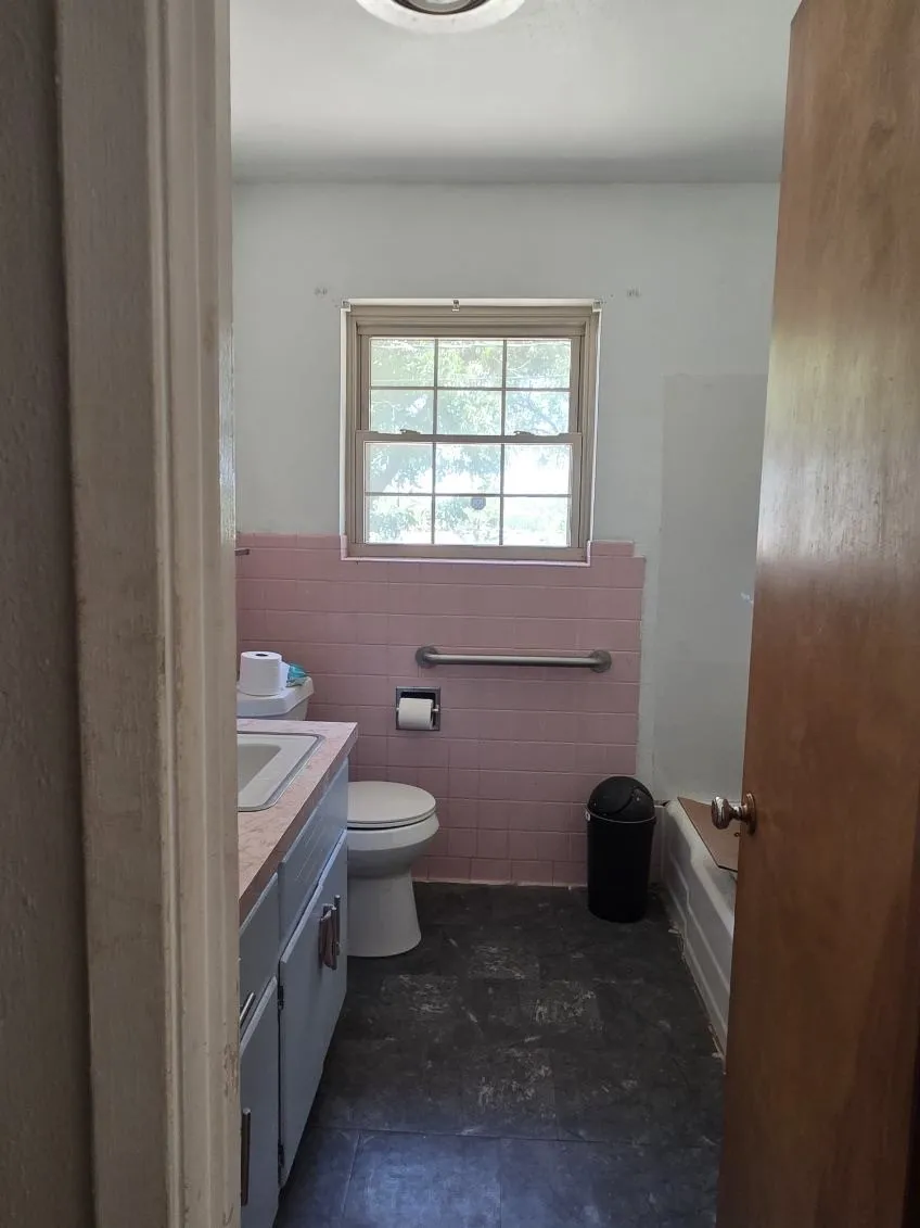 Bathroom featuring a window, tile flooring, and a built-in vanity with sink