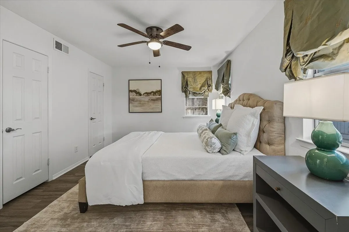 Wood-finish flooring with a ceiling fan with light fixture