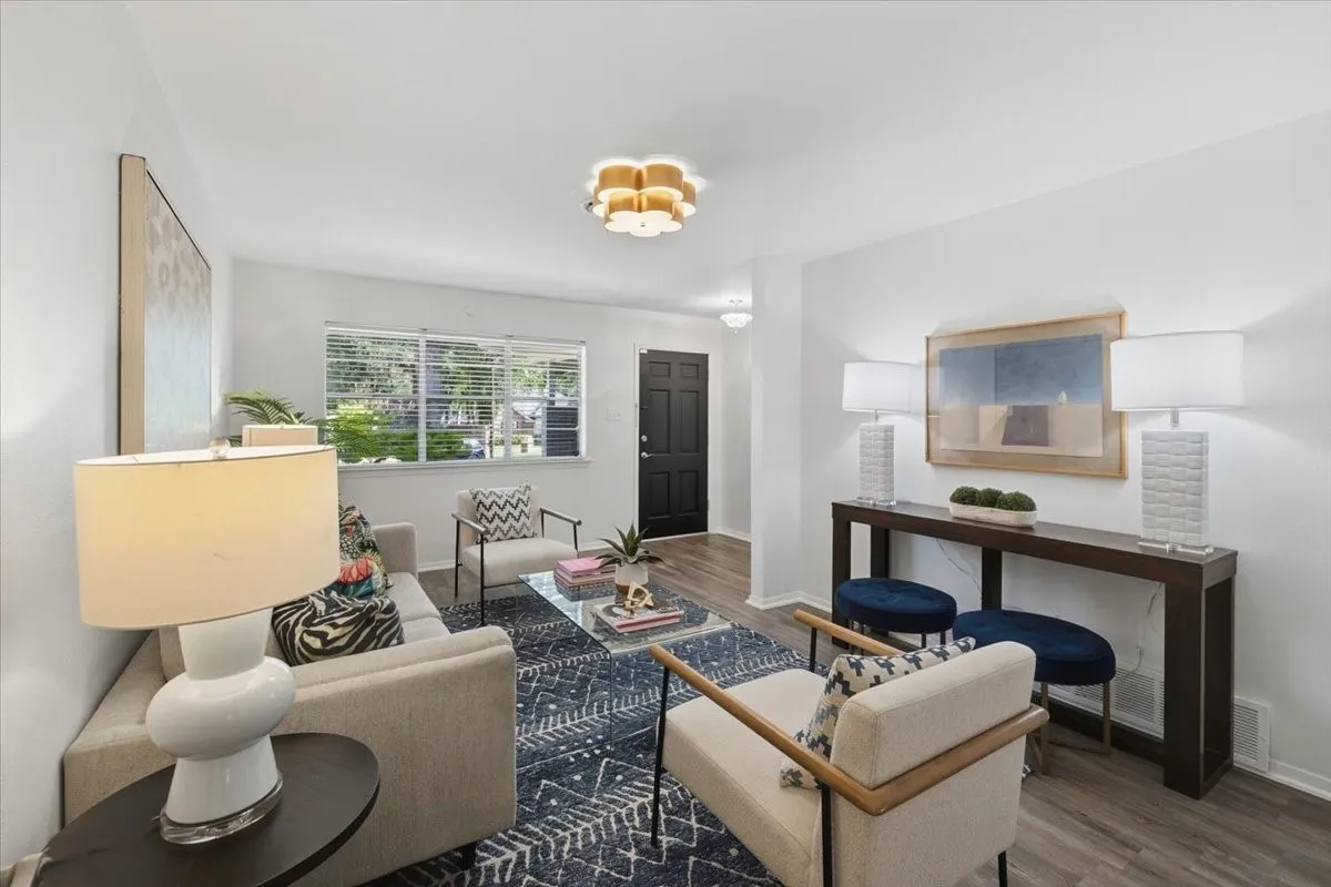 Living area featuring wood-finish flooring and a contemporary overhead light fixture