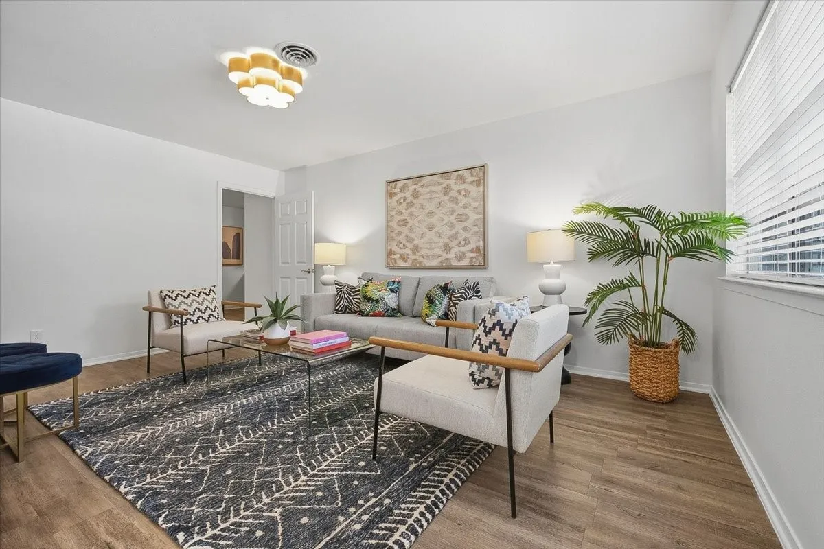 Decorative lighting, wood-finish flooring, white walls, and a window with horizontal blinds