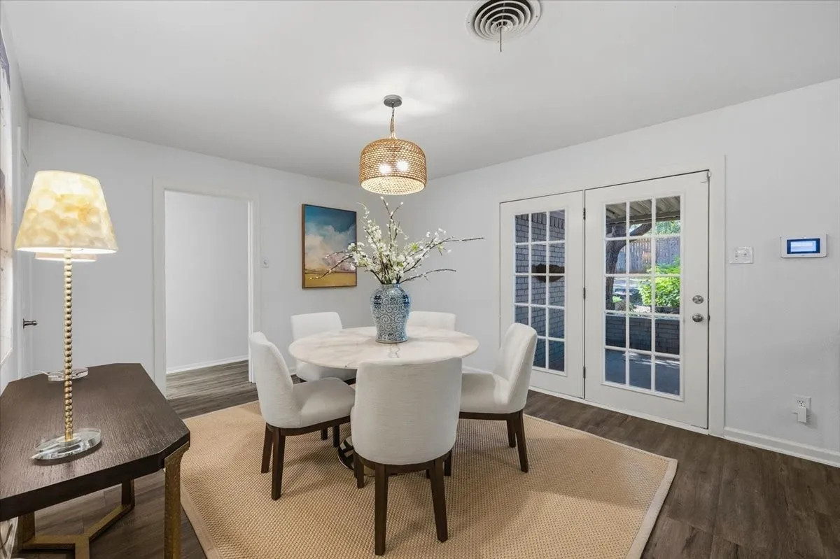 Vinyl Wood-finish flooring, white walls, and a woven pendant light fixture