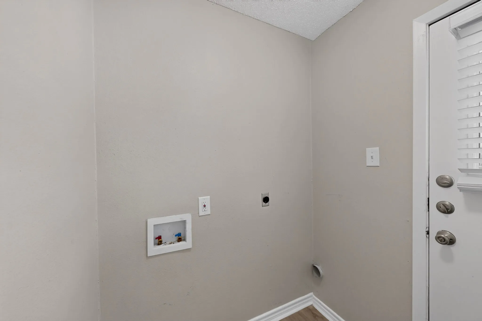 Dedicated laundry area with utility hookups and neutral wall tones