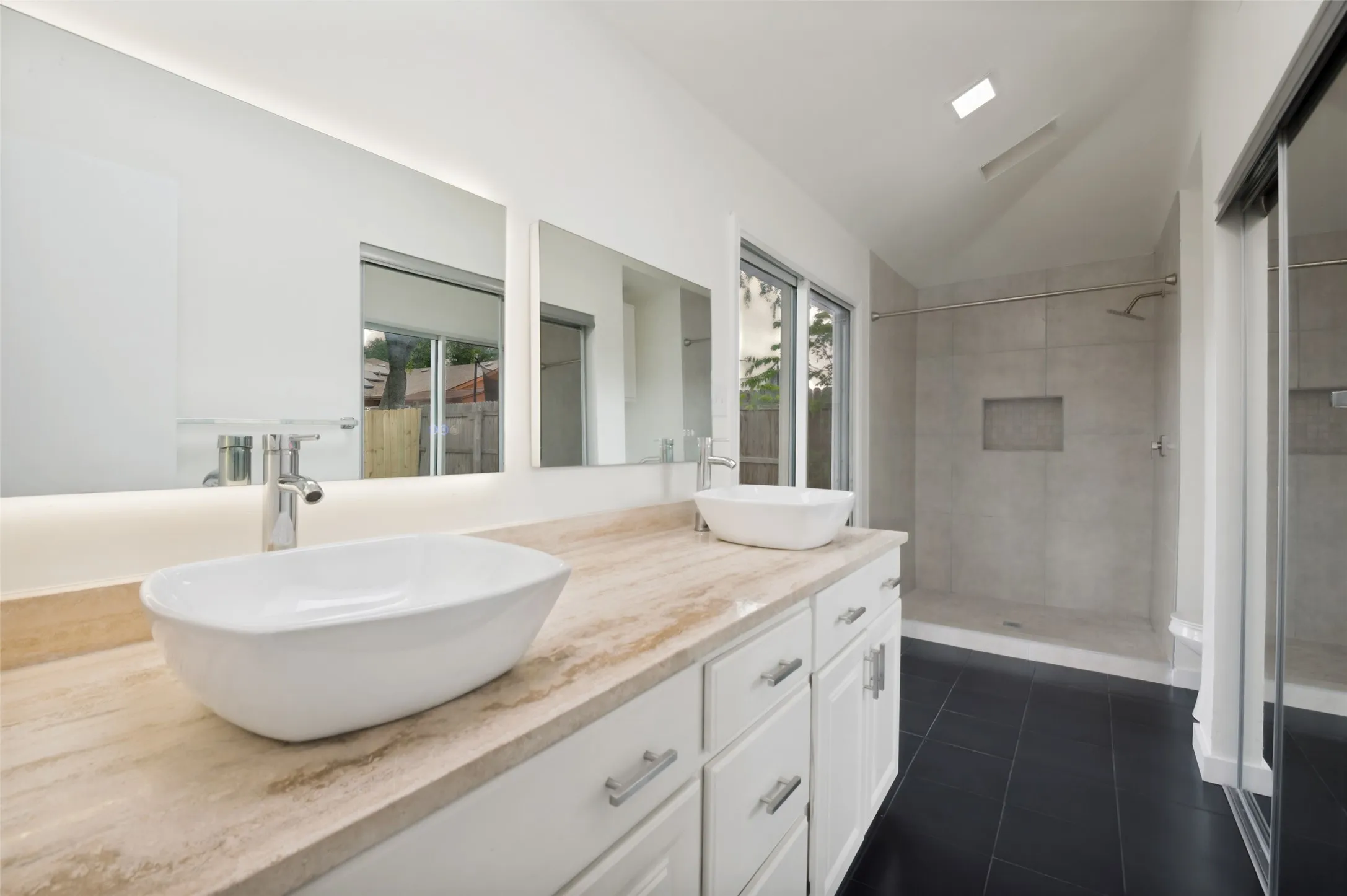 Fully renovated, tiled primary Bathroom.
Double vanity, large walk in shower, light up vanity mirrors, patio #2 access.